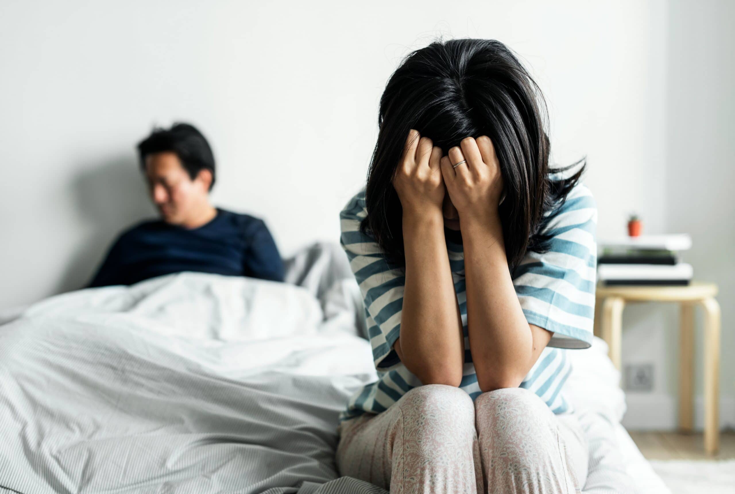 Depressed woman and her husband asking himself how to help a depressed spouse.